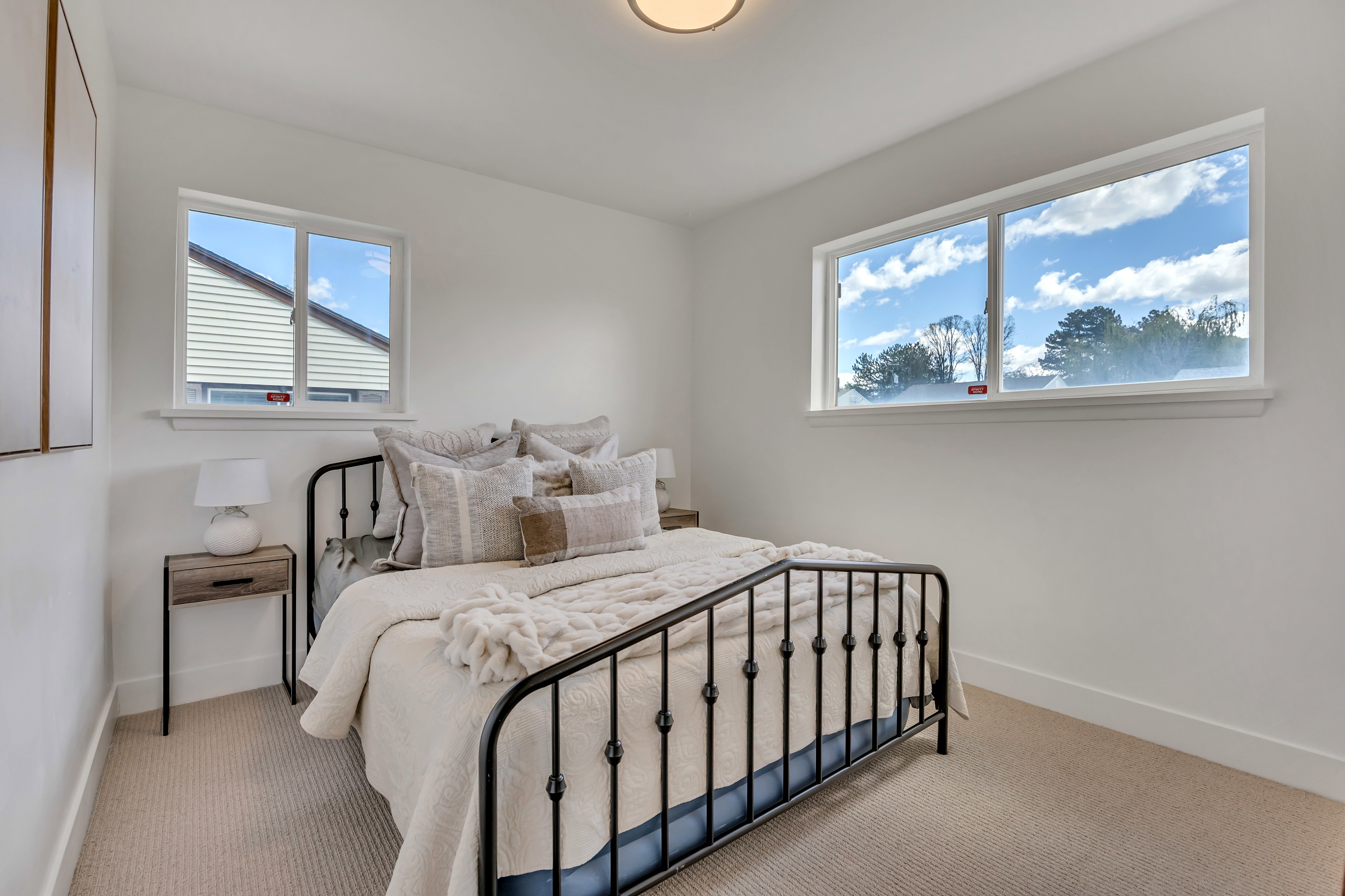 Bright room with white walls and light-toned carpet flooring