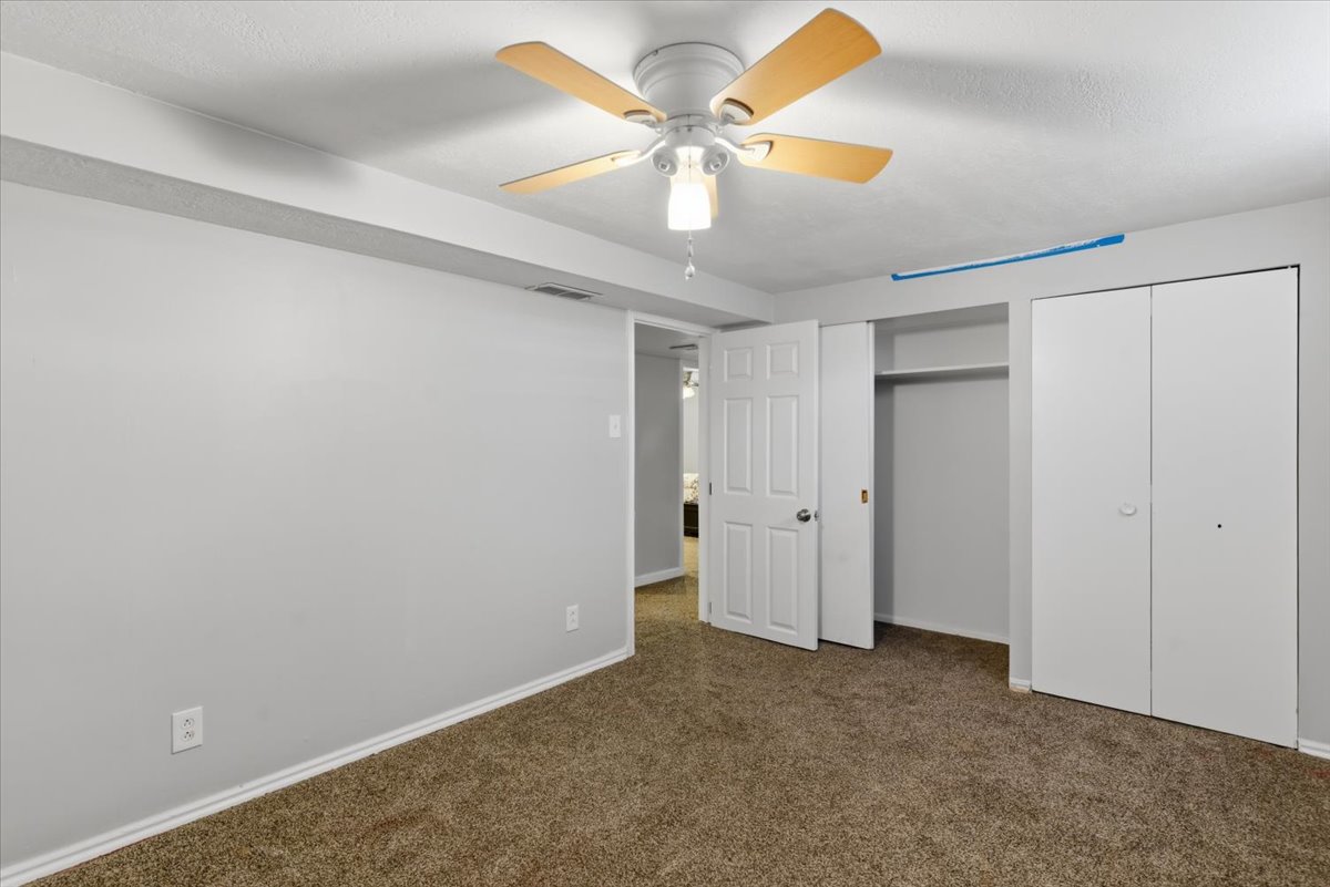 Room featuring wall-to-wall carpeting and neutral wall paint
