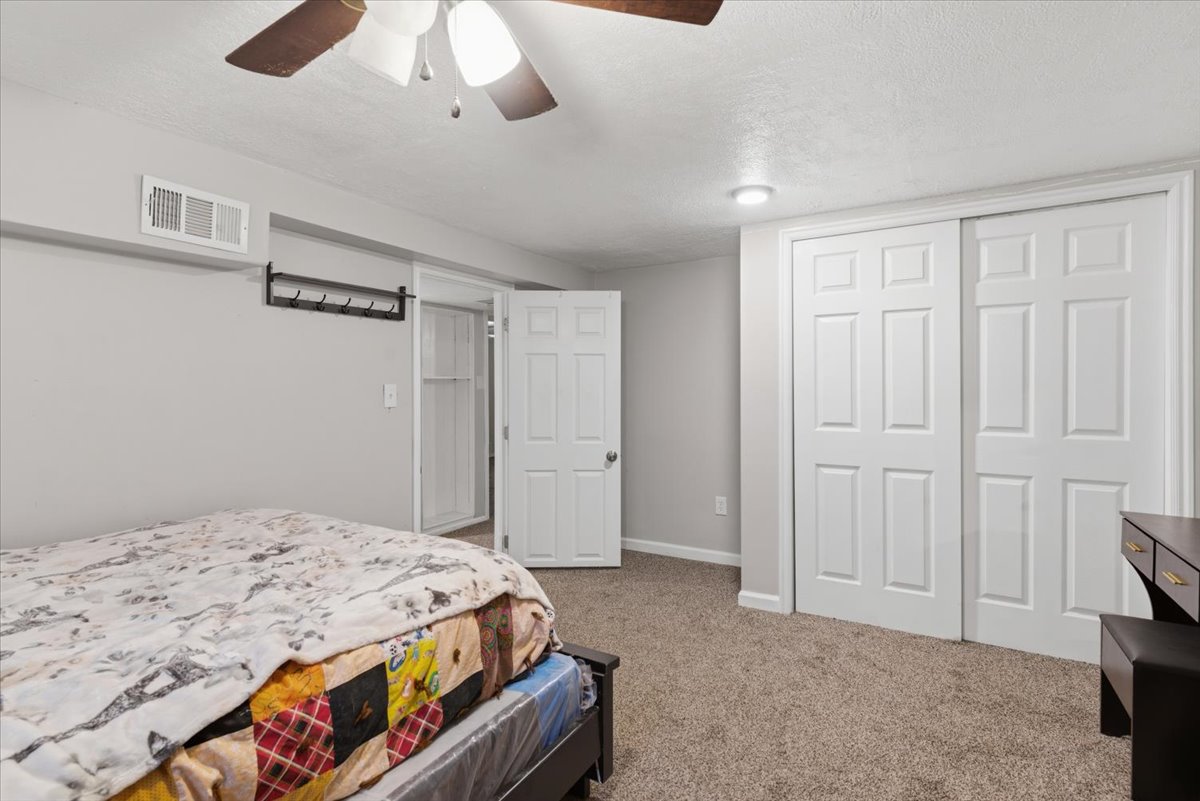 Carpeted room featuring a ceiling fan with integrated lighting, recessed lighting, white trim, and a white six-panel bi-fold closet door