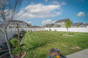 Fenced backyard featuring a residential view