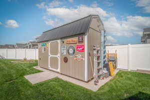 View of outbuilding with a fenced backyard