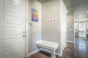 Mudroom featuring recessed lighting, dark wood finished floors, and a textured ceiling