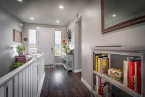 Foyer with recessed lighting and dark wood-style flooring