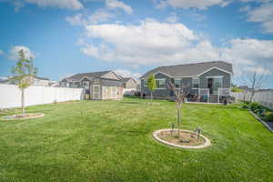 Fenced backyard with a storage unit and a residential view