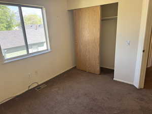 Bedroom featuring brown carpeting and light-toned walls