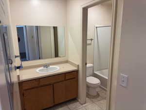 Bathroom vanity featuring a single basin sink and wood-finish cabinetry