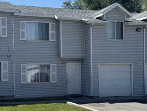 Gray siding exterior with white window shutters