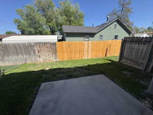 Paved patio area opening to a green lawn