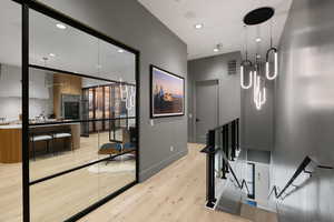 Hardwood-finish flooring extending through the hallway and into the visible living area