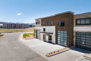 Modern commercial building featuring stone and wood-finish siding