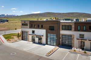 Multi-level commercial structure featuring a stone and wood-panel facade