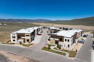 Modern multi-unit structures featuring stone and wood-finish paneling facades