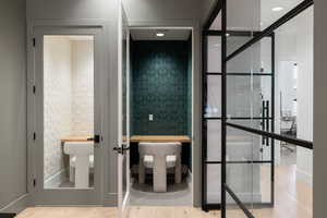 Two dedicated work nooks with built-in wooden desks, recessed lighting, and sound-dampening wall panels