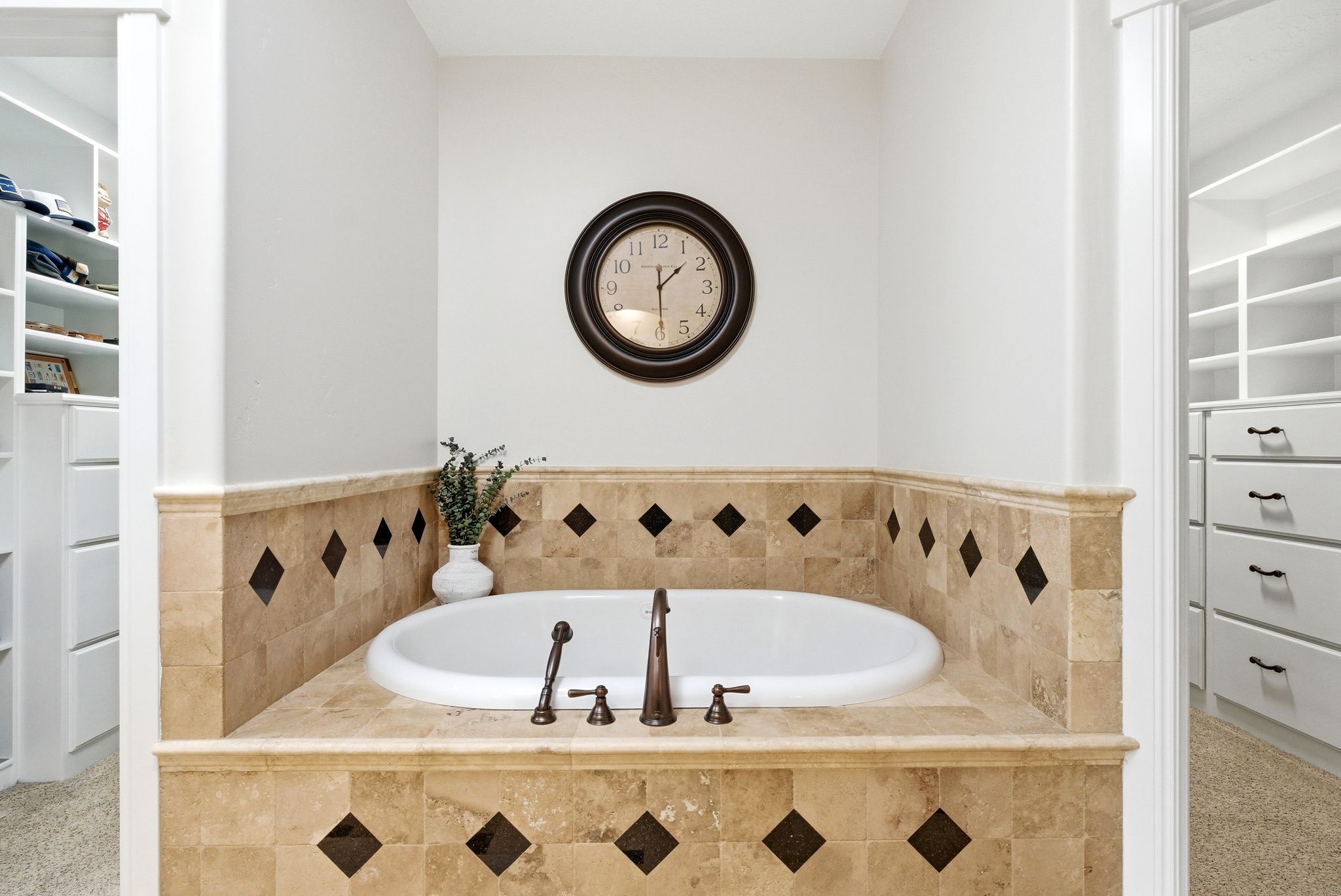 Full bathroom featuring a walk in closet and a bath