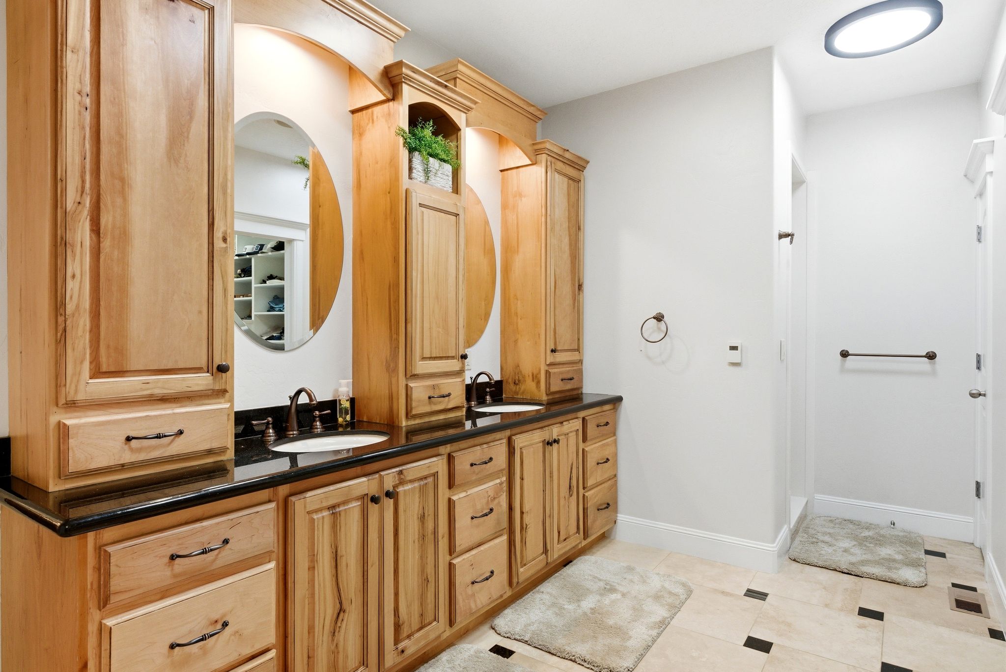 Bathroom featuring double vanity and baseboards