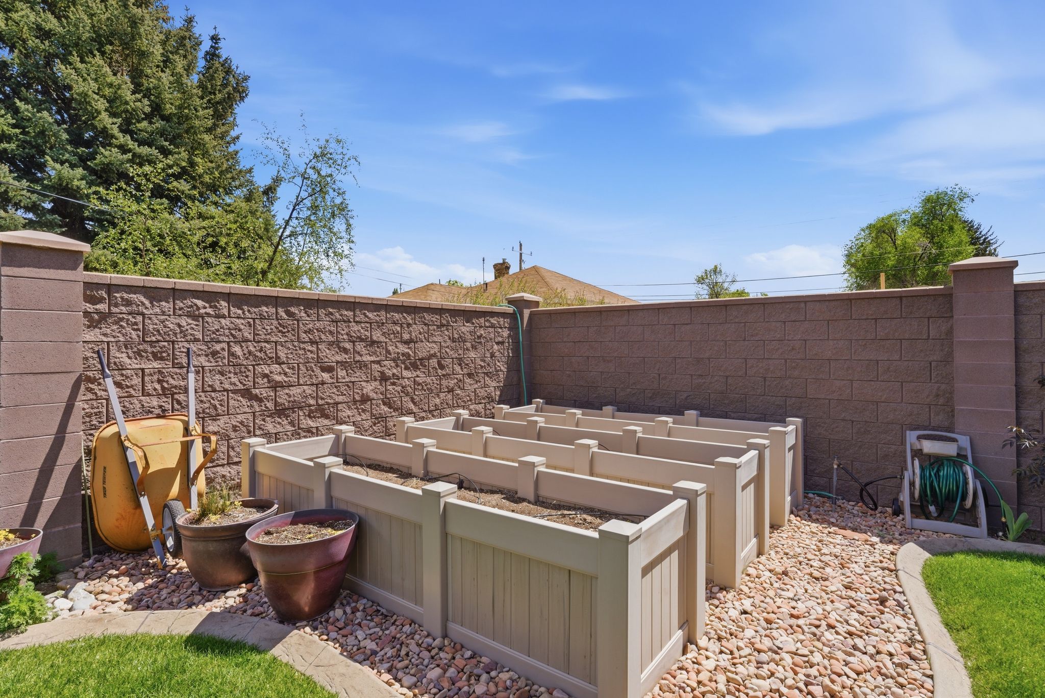 Fenced backyard featuring a garden