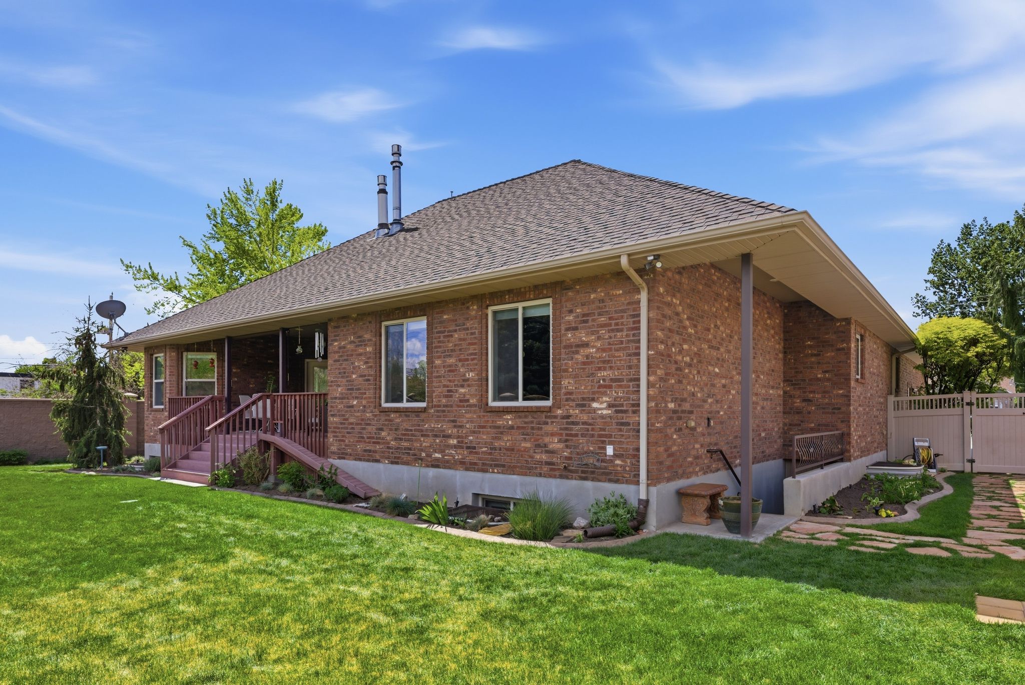 Rear view of property featuring brick siding and a shingled roof