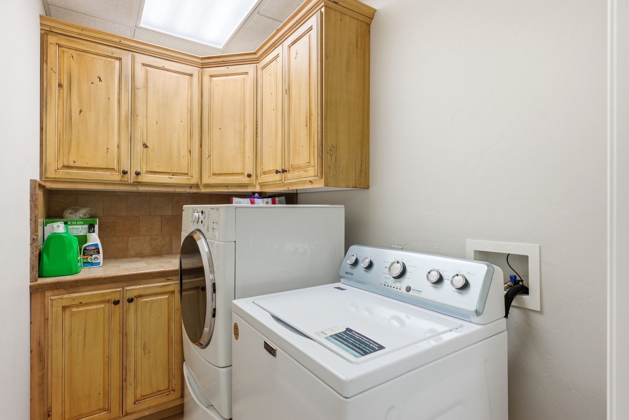 Laundry area with cabinet space and separate washer and dryer