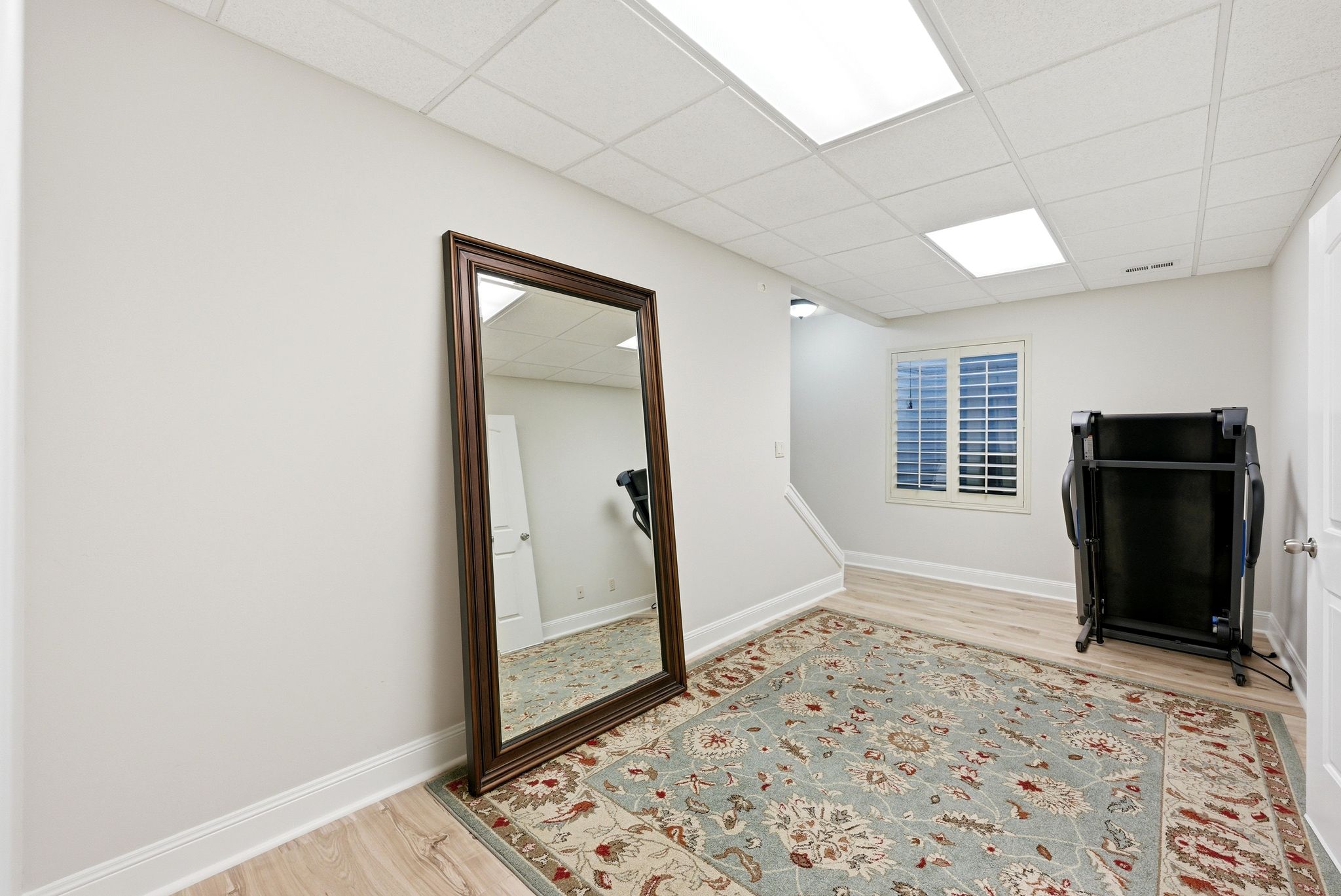 Exercise room with a paneled ceiling