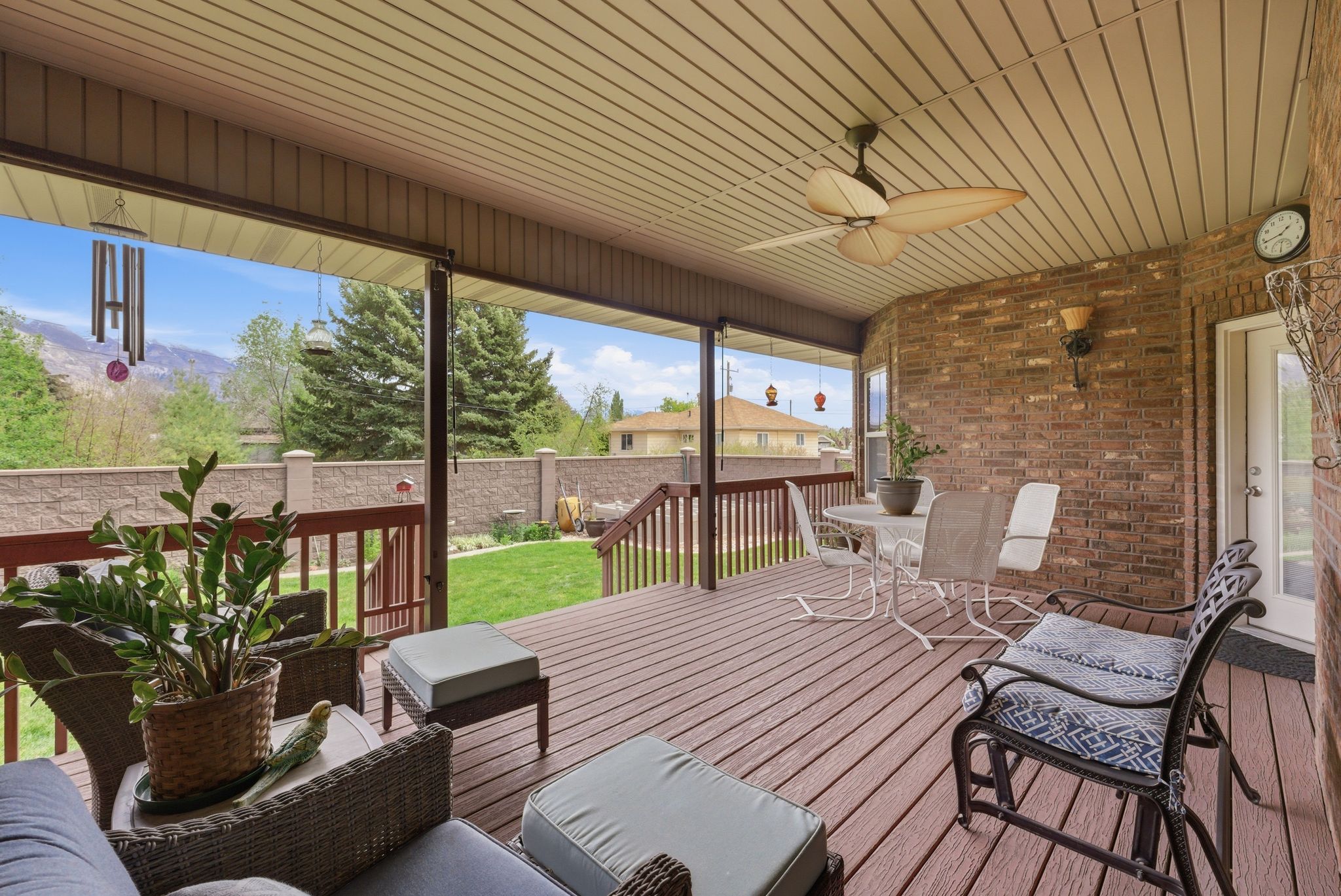Deck with a ceiling fan and outdoor dining area