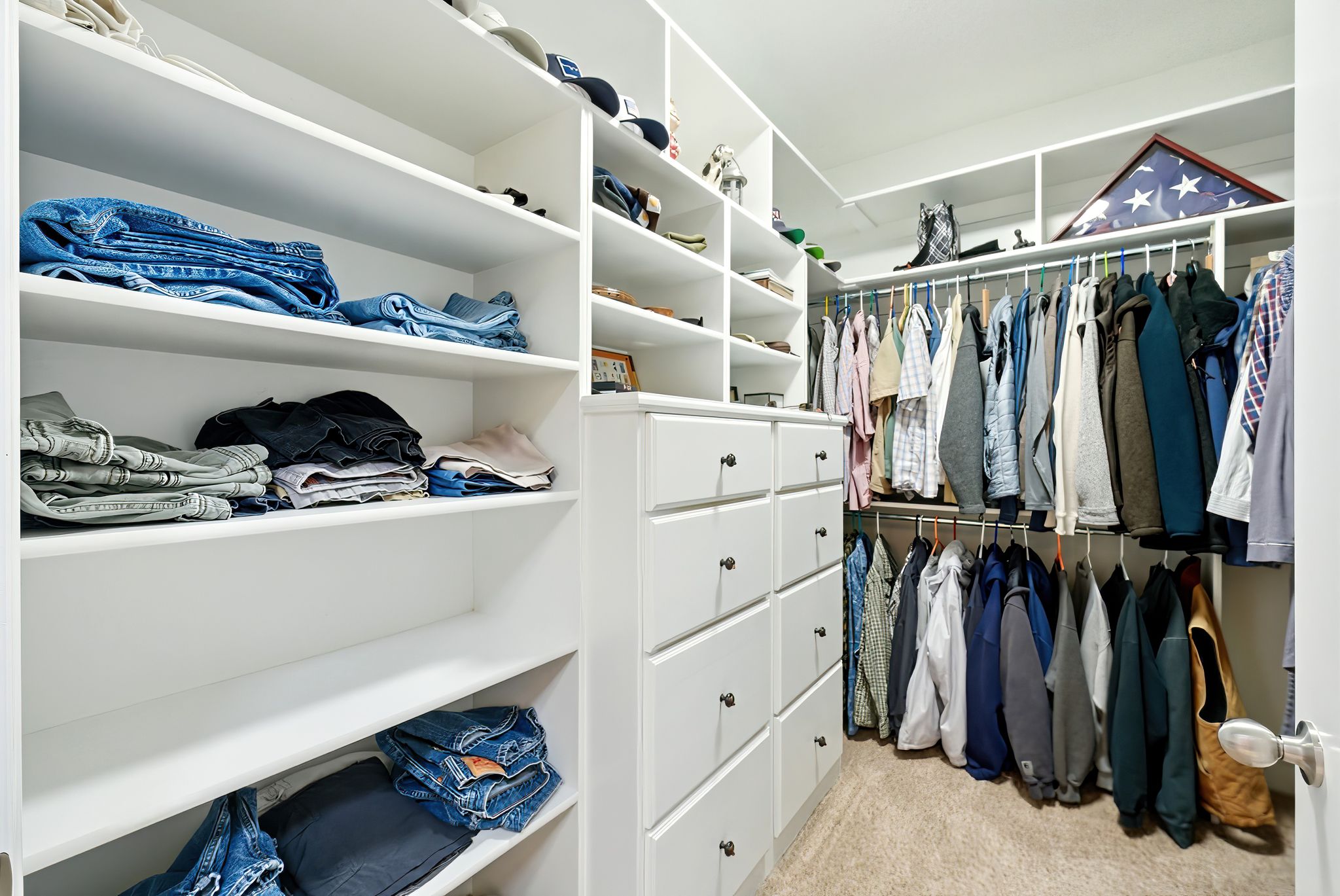 Walk in closet featuring light carpet