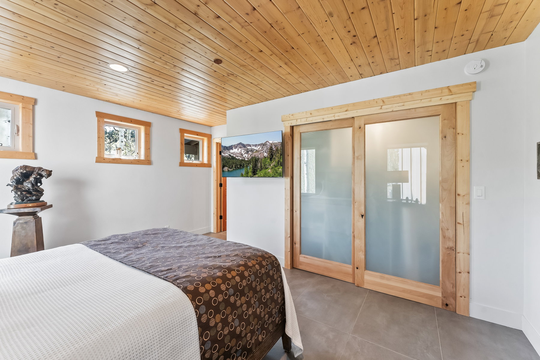 Wood-finish plank ceiling with recessed lighting