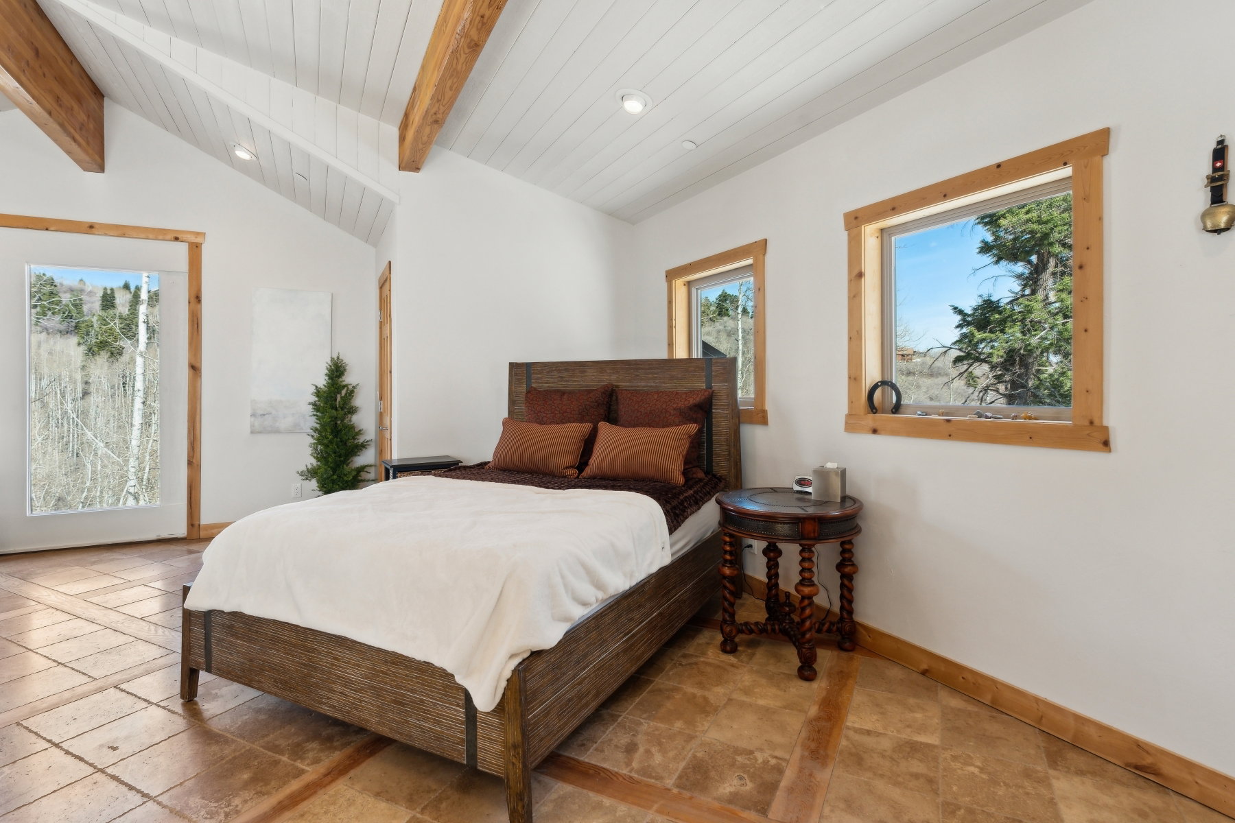 Vaulted ceiling with exposed wood beams and white planking