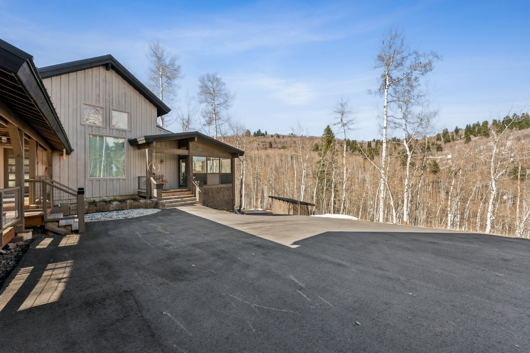 Modern architecture featuring vertical wood siding and a covered entry