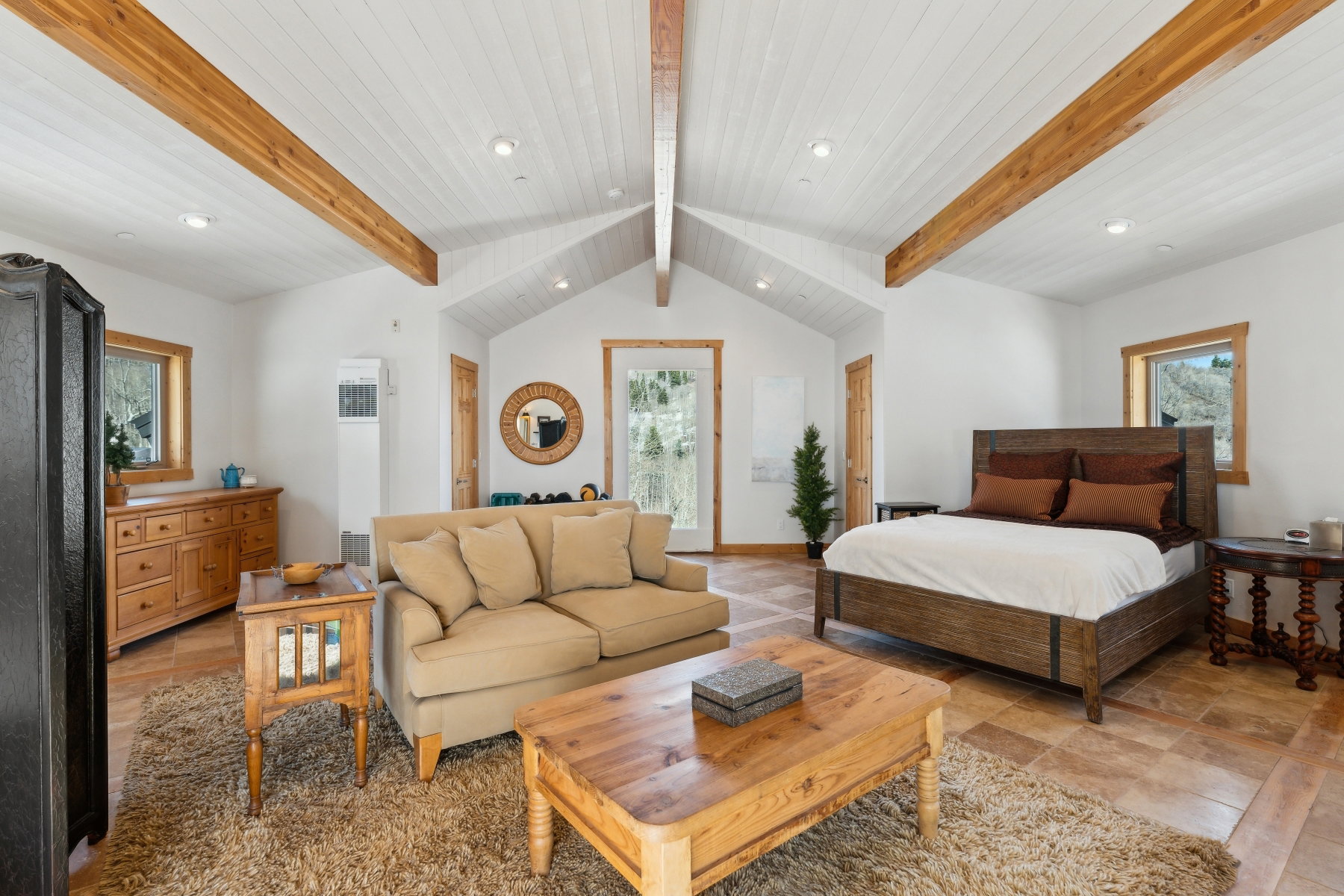Vaulted ceilings with exposed wood beams and recessed lighting
