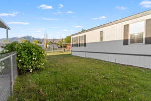 Side exterior with white siding and dark shutters