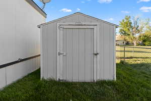 Freestanding storage shed with a gable roof and paneled siding