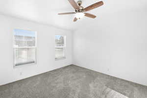 Neutral-toned carpet flooring with white walls and dual windows