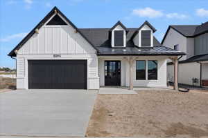 Modern farmhouse exterior featuring white brick and vertical siding accents