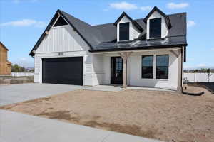 Modern farmhouse exterior featuring white brick and vertical siding