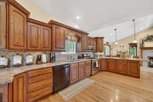 Kitchen featuring abundant wood cabinetry, patterned tile backsplash, and light-tone countertops