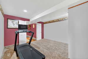 Carpeted interior space with recessed lighting, painted walls, and white trim