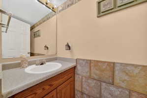 Bathroom vanity with an integrated sink, laminate countertop, and wood-finish cabinetry