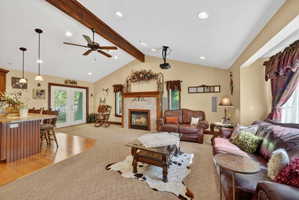 Vaulted ceiling with exposed wood beam and recessed lighting