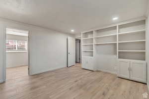 Unfurnished bedroom featuring light wood-style floors, recessed lighting, and crown molding