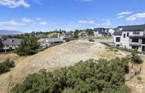 Expansive vacant lot with a gentle slope and natural vegetation