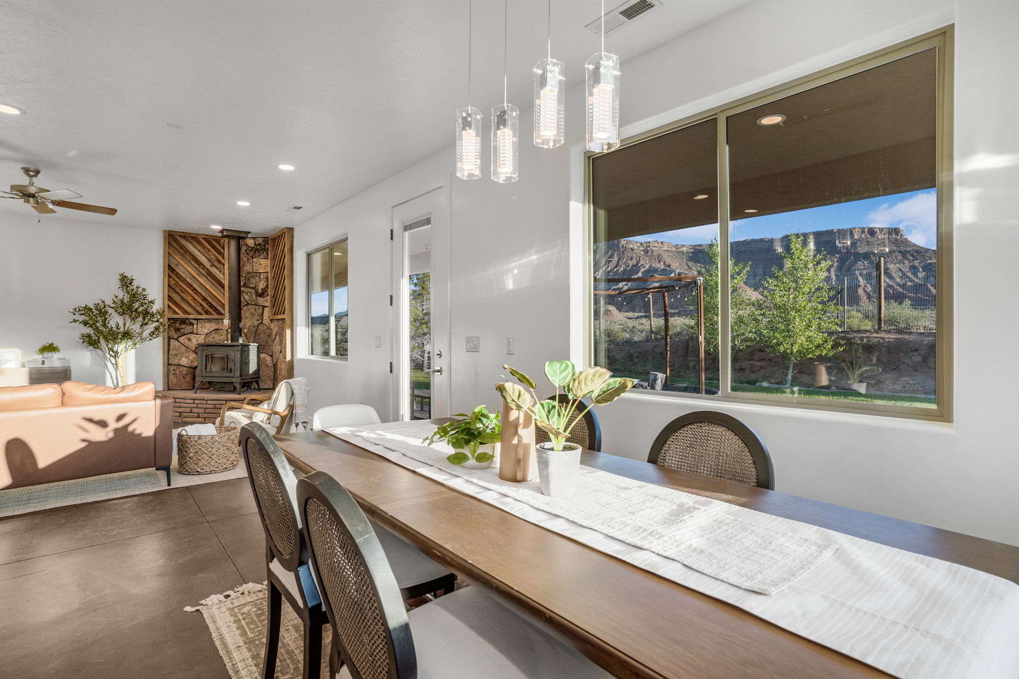 Dining area with wood-finish flooring and a contemporary linear chandelier