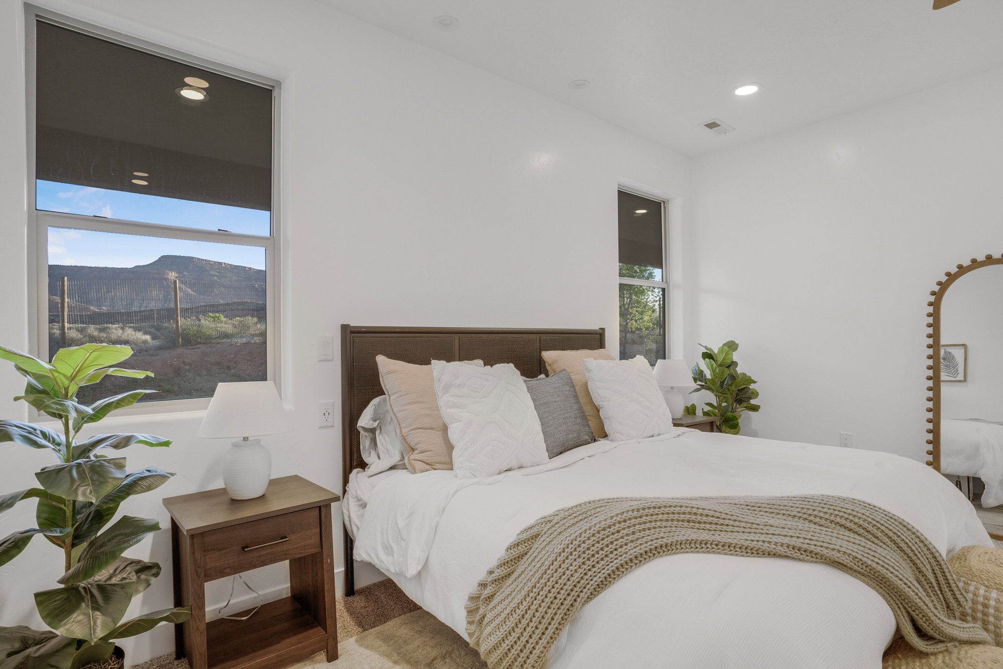 Bright interior space featuring multiple windows, recessed lighting, and a modern upholstered headboard