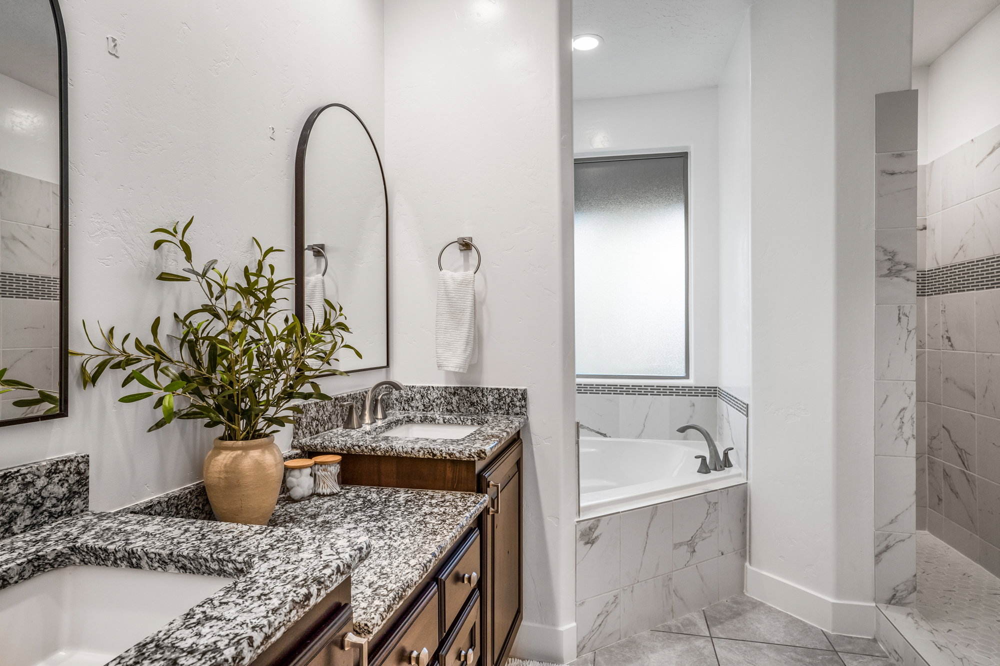 Double vanity featuring granite countertops and undermount sinks