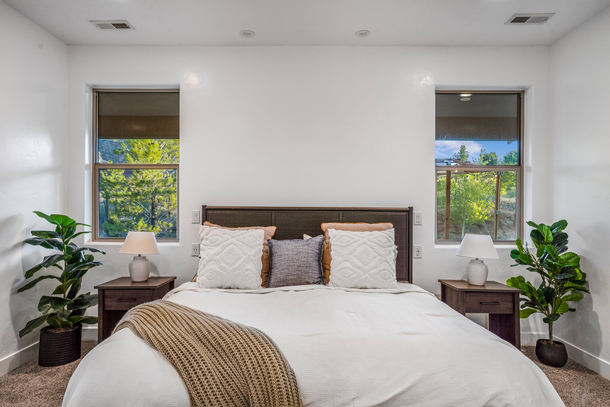 Windowed bedroom featuring abundant natural light, recessed lighting, and wall-to-wall carpeting