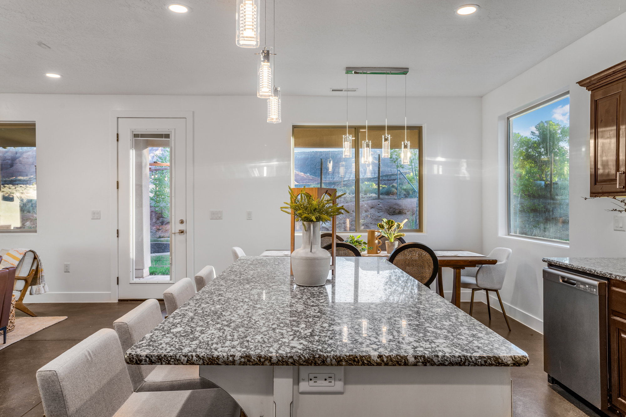Spacious kitchen island featuring a speckled countertop and built-in electrical outlets