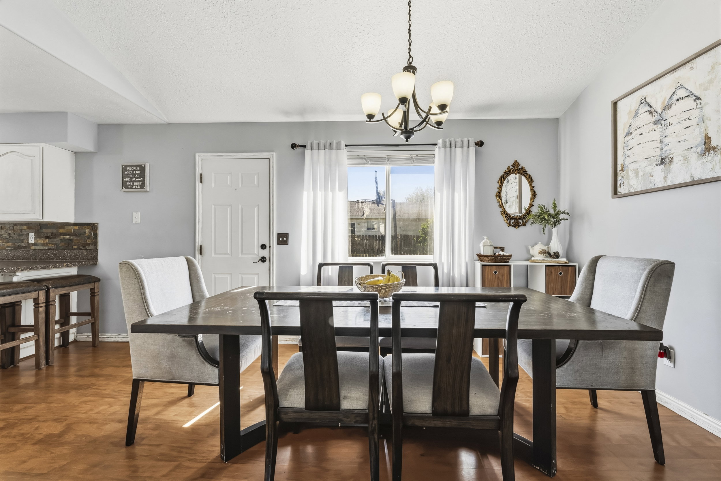 Dining area featuring wood-finish flooring and a multi-arm chandelier