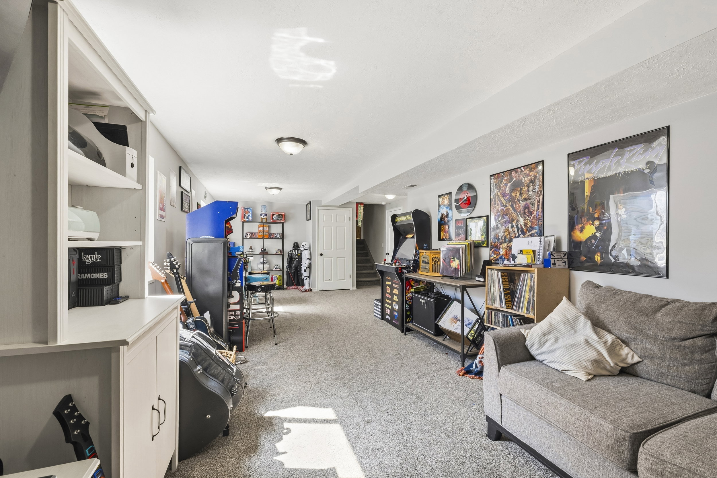 Spacious lower-level area featuring plush carpet, recessed lighting, and a neutral color palette