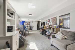 Spacious lower-level area featuring plush carpet, recessed lighting, and a neutral color palette