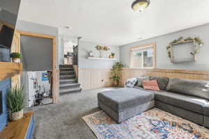 Carpeted living area featuring wainscoting and a recessed window