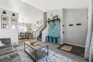 Spacious living area featuring shiplap accent wall, wood-finish flooring, and a dining space